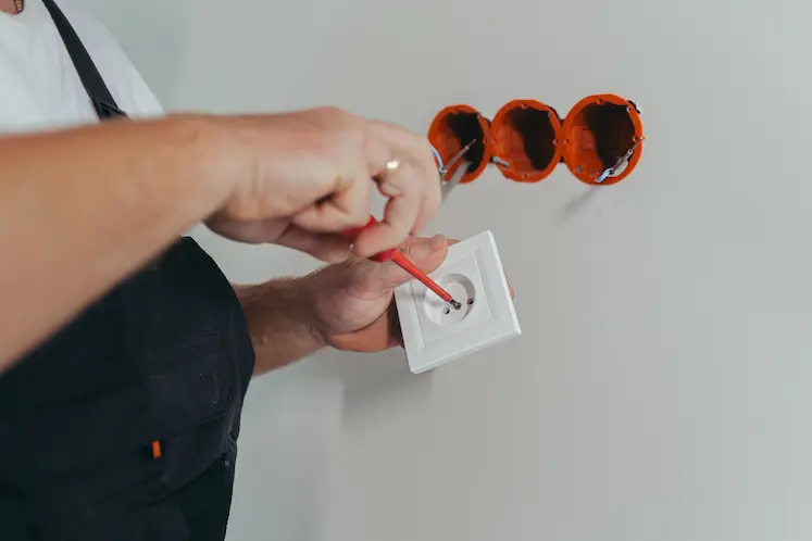 Local electrician working on a fuse box in Oldham