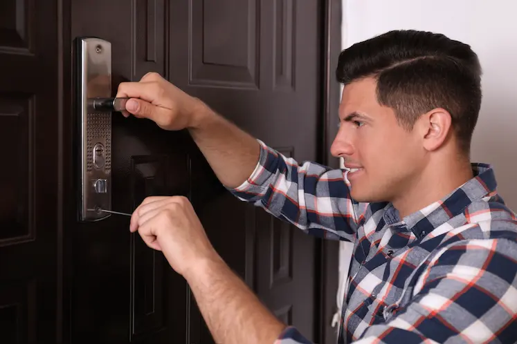 Local locksmith repairing a door lock in Northampton