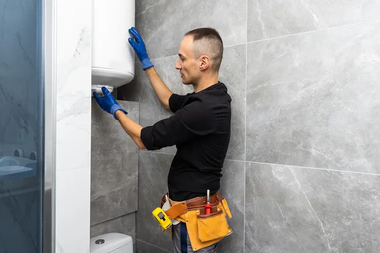 Local plumber carrying out repair work in an Exeter property