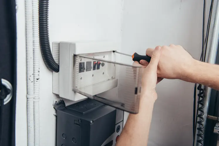 Local electrician repairing an electrical panel in a Greater London property
